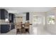 Bright kitchen with shaker cabinets, stainless appliances, and a kitchen island with seating at 1794 Santa Barbara Dr, Dunedin, FL 34698