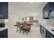 Well-lit kitchen with a breakfast nook and an open view into the cozy living room at 1794 Santa Barbara Dr, Dunedin, FL 34698