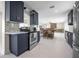 Modern kitchen with stainless steel appliances, contrasting cabinets, and an open floorplan at 1794 Santa Barbara Dr, Dunedin, FL 34698
