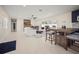 Spacious living area with tile floors, a stone fireplace, and an adjacent kitchen bar at 1794 Santa Barbara Dr, Dunedin, FL 34698