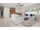 Inviting living area with a rustic fireplace, comfortable seating, and bright natural light at 1794 Santa Barbara Dr, Dunedin, FL 34698