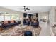 Bright living room featuring modern furniture, a plush rug, and an open floor plan to the kitchen at 1794 Santa Barbara Dr, Dunedin, FL 34698