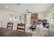 Cozy living room featuring a stone fireplace, plush seating, and large windows for natural light at 1794 Santa Barbara Dr, Dunedin, FL 34698