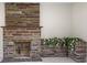 Comfortable living room with a classic stone fireplace and natural lighting at 1794 Santa Barbara Dr, Dunedin, FL 34698