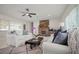 Bright and airy living room with a stone fireplace, plush seating, and abundant natural light at 1794 Santa Barbara Dr, Dunedin, FL 34698