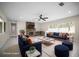 Spacious living room boasting a stone fireplace, plush seating, and abundant natural light from large windows at 1794 Santa Barbara Dr, Dunedin, FL 34698