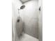 Bright bathroom showing a marble-tiled stand up shower with built in shelf at 1794 Santa Barbara Dr, Dunedin, FL 34698