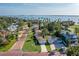 Waterfront street view of the neighborhood with palm trees lining the road and views of the bay at 1794 Santa Barbara Dr, Dunedin, FL 34698