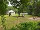 Serene backyard setting with a hammock, picnic table, and fire pit, surrounded by lush greenery at 18452 Fort Dade Ave, Brooksville, FL 34601
