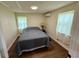 Cozy bedroom featuring natural light, wood-look floors, and a comfortable bed setting at 18452 Fort Dade Ave, Brooksville, FL 34601
