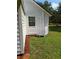 Exterior shot showing the home's siding and outdoor features, including the yard and greenery at 18452 Fort Dade Ave, Brooksville, FL 34601