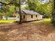 Charming single-story home with a cozy front porch and mature trees in a sprawling yard at 18452 Fort Dade Ave, Brooksville, FL 34601
