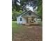 Charming home with a cozy front porch, complemented by a decorative accent and well-maintained landscaping at 18452 Fort Dade Ave, Brooksville, FL 34601