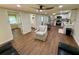 Bright, open living area with wood floors flowing into a modern kitchen and well-appointed bathroom at 18452 Fort Dade Ave, Brooksville, FL 34601