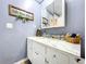This bathroom showcases a vintage-style vanity with marble countertop and stylish decor at 1902 Rebecca Rd, Lutz, FL 33548