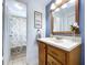 Bathroom featuring a wood vanity, large mirror, and a shower/tub with a patterned curtain at 1902 Rebecca Rd, Lutz, FL 33548