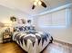 Bedroom featuring one bed with a star patterned quilt, hardwood floors, and a window with blinds at 1902 Rebecca Rd, Lutz, FL 33548