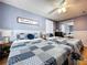 Bedroom featuring two cozy beds with decorative quilts, mirrored closet, and a blue accent wall at 1902 Rebecca Rd, Lutz, FL 33548