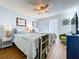 Bedroom featuring two beds, a ceiling fan, and a window with vertical blinds at 1902 Rebecca Rd, Lutz, FL 33548