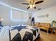 This bedroom offers a cozy atmosphere with warm wood floors and a comfortable, stylish bed at 1902 Rebecca Rd, Lutz, FL 33548