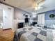 Cozy bedroom with two beds featuring matching quilts, neutral walls, ceiling fan, and a TV at 1902 Rebecca Rd, Lutz, FL 33548