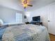 Bedroom featuring two beds, a ceiling fan, and a window with vertical blinds at 1902 Rebecca Rd, Lutz, FL 33548