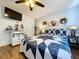 This bedroom is illuminated by a ceiling fan and features a TV and an adjacent white workspace at 1902 Rebecca Rd, Lutz, FL 33548