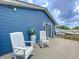 Relax on the deck with rocking chairs, offering a peaceful outdoor retreat with stylish blue siding at 1902 Rebecca Rd, Lutz, FL 33548