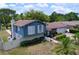 Charming blue two-story home featuring manicured landscaping and a welcoming entrance, blending comfort and curb appeal at 1902 Rebecca Rd, Lutz, FL 33548
