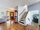 Inviting foyer with hardwood floors, an elegant staircase, and a charming display case at 1902 Rebecca Rd, Lutz, FL 33548
