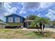 Charming two-story home featuring blue siding, white shutters, and well-maintained landscaping at 1902 Rebecca Rd, Lutz, FL 33548