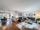 Spacious living area seamlessly connected to the dining room, featuring hardwood floors and natural light at 1902 Rebecca Rd, Lutz, FL 33548