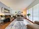 Inviting living room featuring plush sofas, a stylish rug, and an abundance of natural light at 1902 Rebecca Rd, Lutz, FL 33548