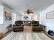 Spacious living room featuring hardwood floors, a ceiling fan, and a comfortable seating arrangement at 1902 Rebecca Rd, Lutz, FL 33548