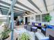 Inviting outdoor patio with comfortable seating, ceiling fan, and a stylish rug, perfect for relaxation at 1902 Rebecca Rd, Lutz, FL 33548