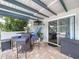 Cozy outdoor patio with bar seating, plants, and a view to the outdoors at 1902 Rebecca Rd, Lutz, FL 33548