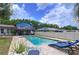 Beautiful pool area with brick pavers, lounge chairs, and lush landscaping, perfect for outdoor relaxation at 1902 Rebecca Rd, Lutz, FL 33548