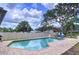 Inviting pool area with brick pavers, lounge chairs, and a well-maintained fence for privacy at 1902 Rebecca Rd, Lutz, FL 33548