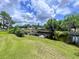 Scenic waterfront with lush green lawn and private boat docks, offering an idyllic lakeside lifestyle at 1902 Rebecca Rd, Lutz, FL 33548
