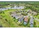 Wide aerial view of lakeside community showcasing home, surrounding neighborhood, and a pond at 19191 Pease Pl, Lutz, FL 33558