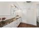 Modern bathroom with granite countertop, dual shower and vanity with hardwood floors at 19191 Pease Pl, Lutz, FL 33558