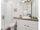 Bright bathroom with a glass-enclosed shower, a granite countertop, and white cabinets at 19191 Pease Pl, Lutz, FL 33558