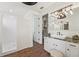 Bathroom featuring vanity and sink, a walk in shower, and doorway to a walk in closet at 19191 Pease Pl, Lutz, FL 33558