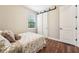 Charming bedroom showcasing a sliding closet door and a window at 19191 Pease Pl, Lutz, FL 33558