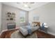 Cozy bedroom with modern furniture, wood floors, shelves, and abundant natural light at 19191 Pease Pl, Lutz, FL 33558