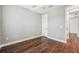 Neutral-toned bedroom with hard flooring and white door at 19191 Pease Pl, Lutz, FL 33558
