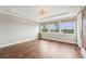 Spacious bedroom with wood floors, tray ceilings, and windows overlooking a lake at 19191 Pease Pl, Lutz, FL 33558