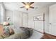Neutral bedroom offering wood-look floors, ceiling fan, and built in bench and shelving at 19191 Pease Pl, Lutz, FL 33558