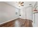 Neutral bedroom offering wood-look floors, ceiling fan, and built in bench and shelving at 19191 Pease Pl, Lutz, FL 33558