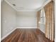 Bedroom with wood floors, large window with patterned curtain at 19191 Pease Pl, Lutz, FL 33558